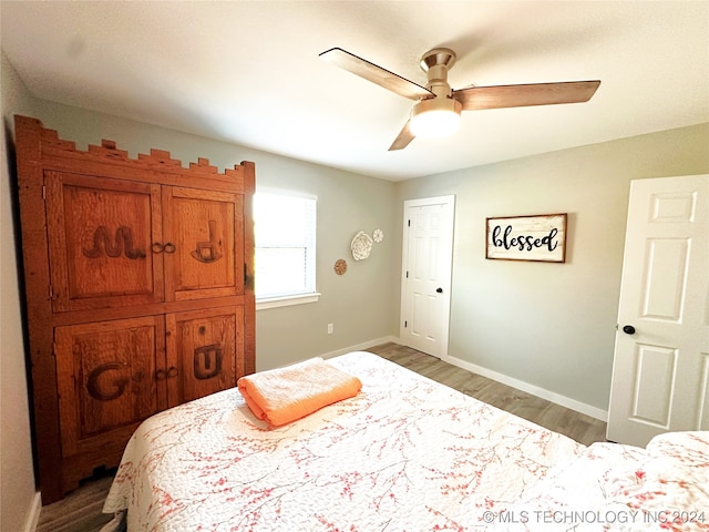 bedroom with ceiling fan and hardwood / wood-style flooring