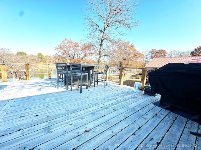 wooden deck with a water view