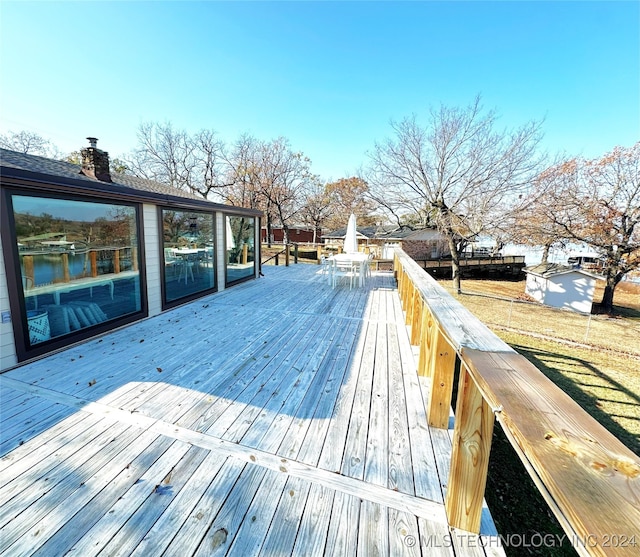 wooden terrace featuring a water view