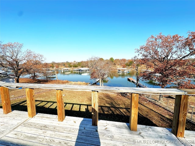 wooden terrace featuring a dock and a water view