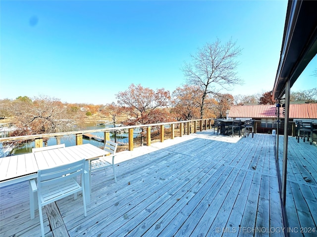 wooden deck featuring a water view