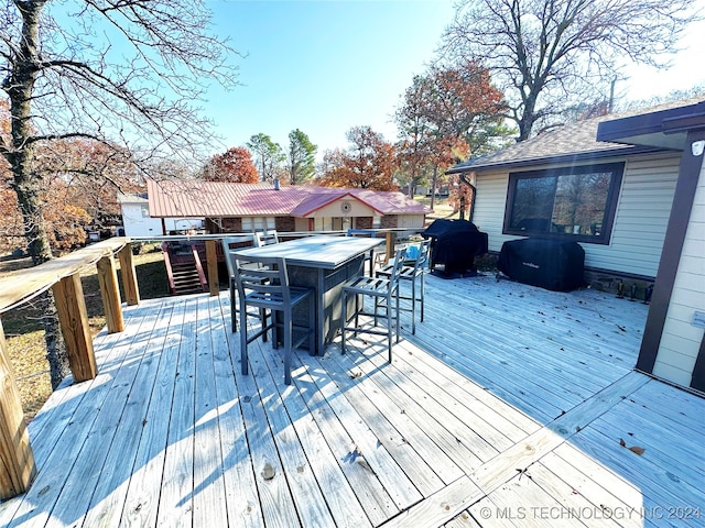 wooden terrace featuring grilling area