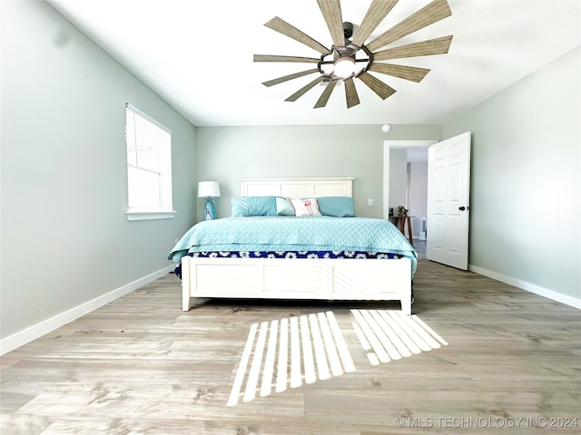 bedroom with ceiling fan and light hardwood / wood-style flooring