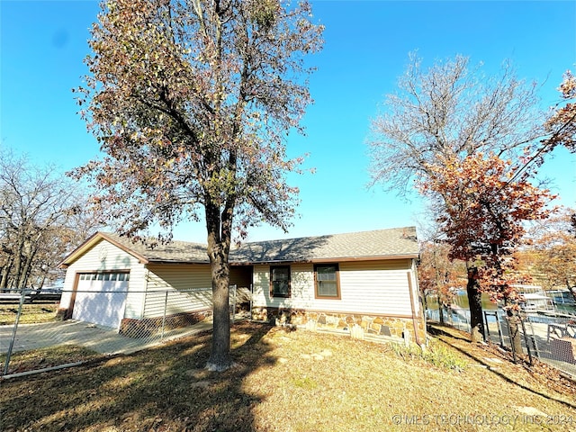 ranch-style home with a front lawn and a garage