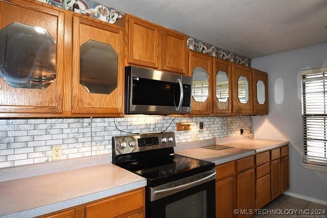 kitchen featuring appliances with stainless steel finishes and tasteful backsplash