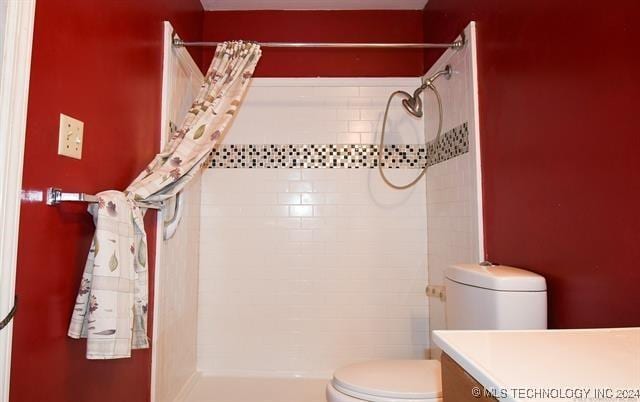 bathroom featuring vanity, toilet, and walk in shower