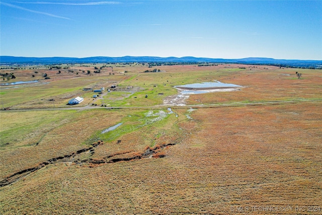 drone / aerial view with a mountain view and a rural view