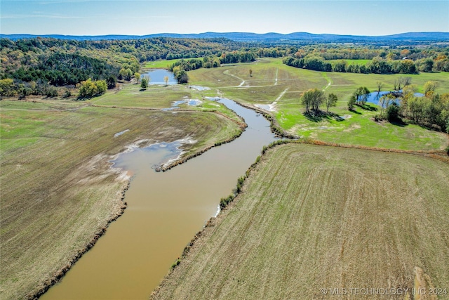 birds eye view of property featuring a rural view and a water and mountain view