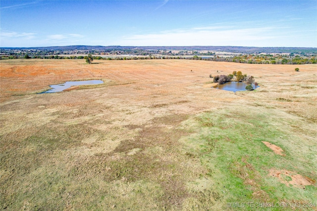 drone / aerial view with a water view and a rural view