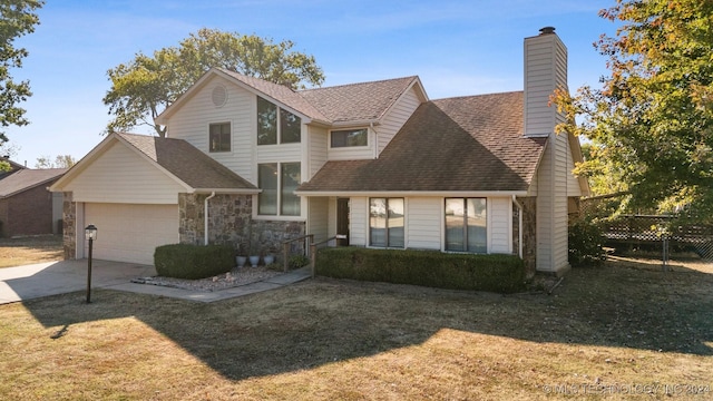 view of front of home with a front yard and a garage