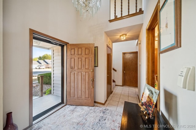 entrance foyer with light tile patterned floors and a chandelier