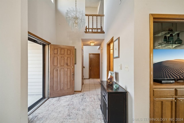 hallway featuring a chandelier and light tile patterned flooring