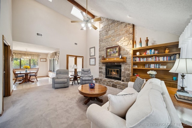 carpeted living room featuring high vaulted ceiling, ceiling fan, a fireplace, a textured ceiling, and beam ceiling