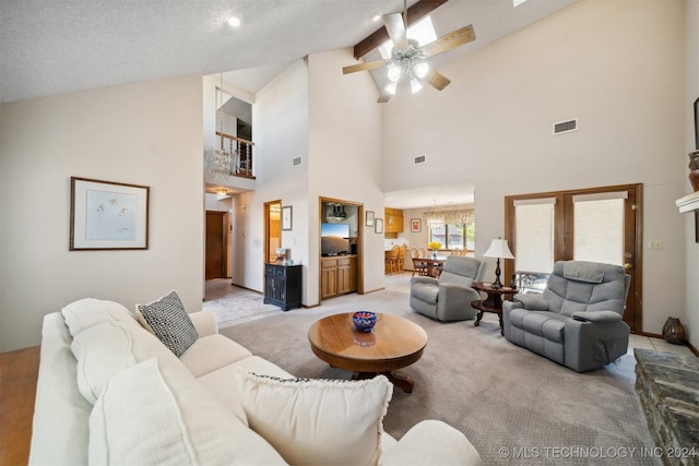 living room with a textured ceiling, light colored carpet, high vaulted ceiling, and ceiling fan