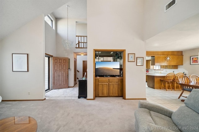 carpeted living room featuring a high ceiling