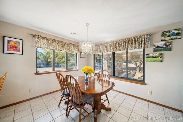 dining space with light tile patterned floors and a chandelier