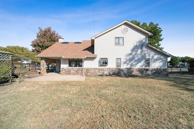 back of property featuring a yard and a patio