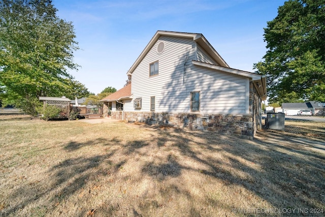 view of home's exterior with a lawn and a wooden deck