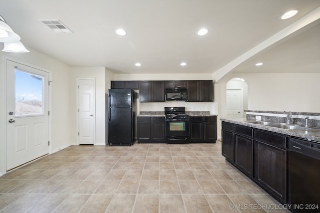 kitchen featuring sink, dark brown cabinetry, and black appliances