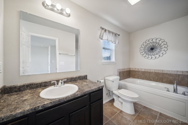 bathroom featuring a washtub, vanity, and toilet