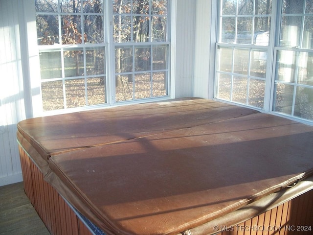 sunroom with plenty of natural light and a hot tub