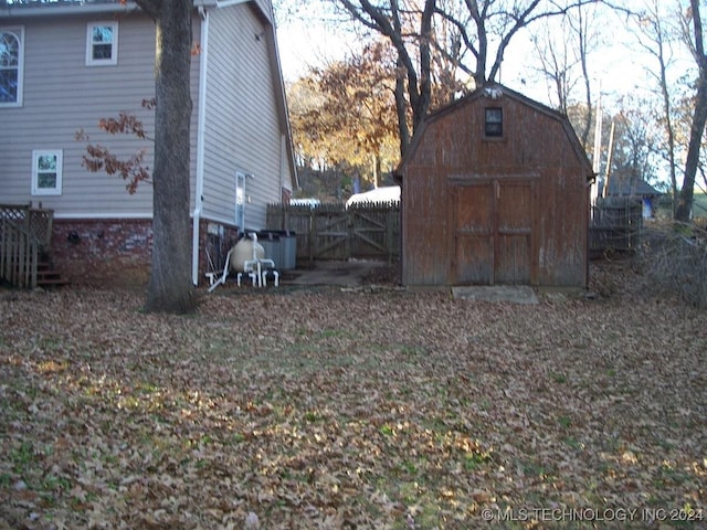 view of side of home featuring a storage unit