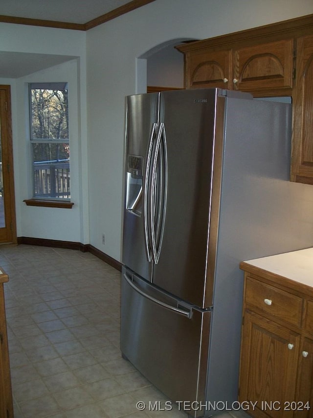 kitchen featuring stainless steel fridge and crown molding