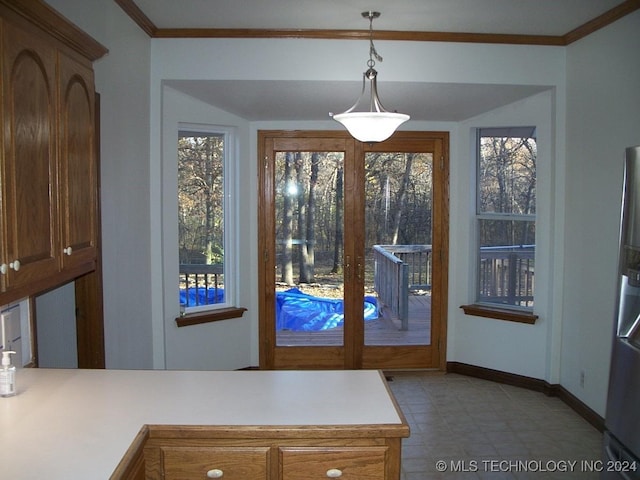 doorway with plenty of natural light and ornamental molding