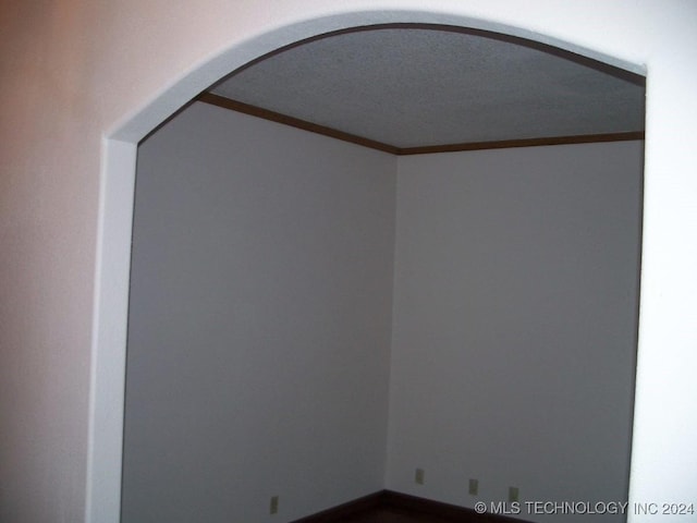 unfurnished room with crown molding