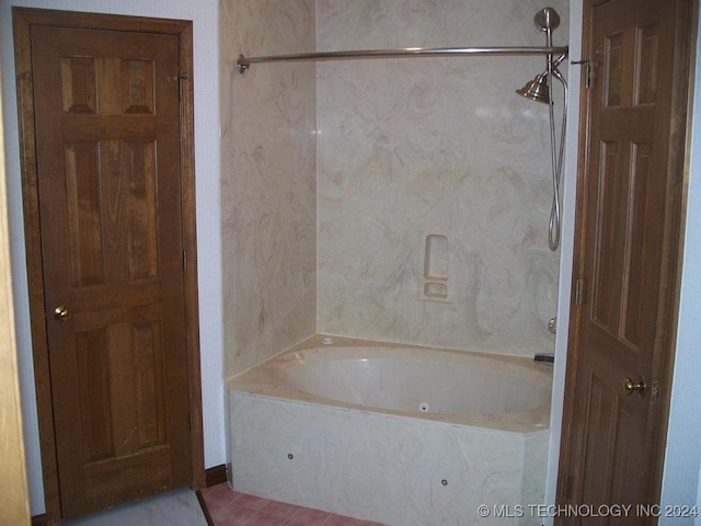 bathroom with tile patterned floors and bathtub / shower combination