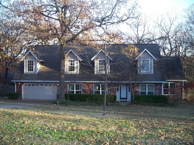 cape cod-style house with a front lawn and a garage