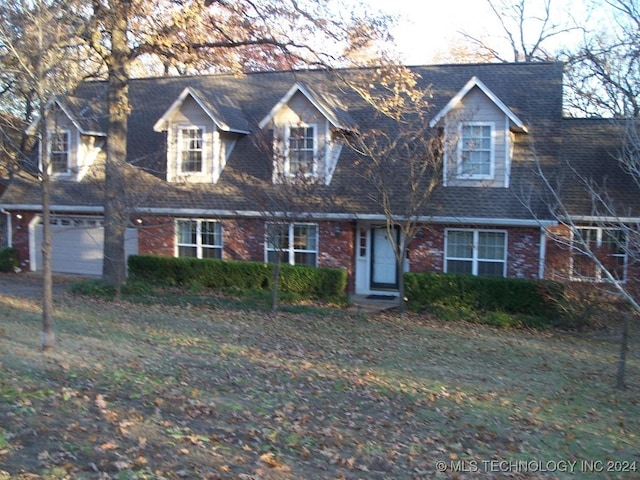 cape cod-style house with a garage