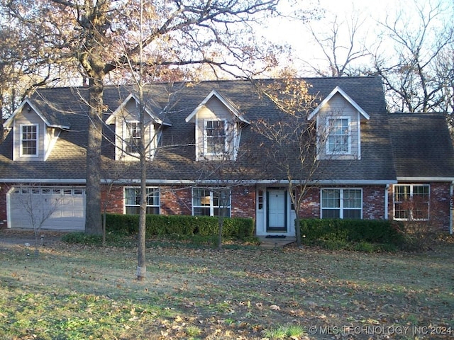 new england style home featuring a garage