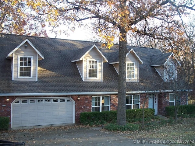 cape cod house with a garage