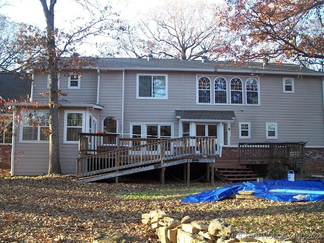 back of property featuring a wooden deck