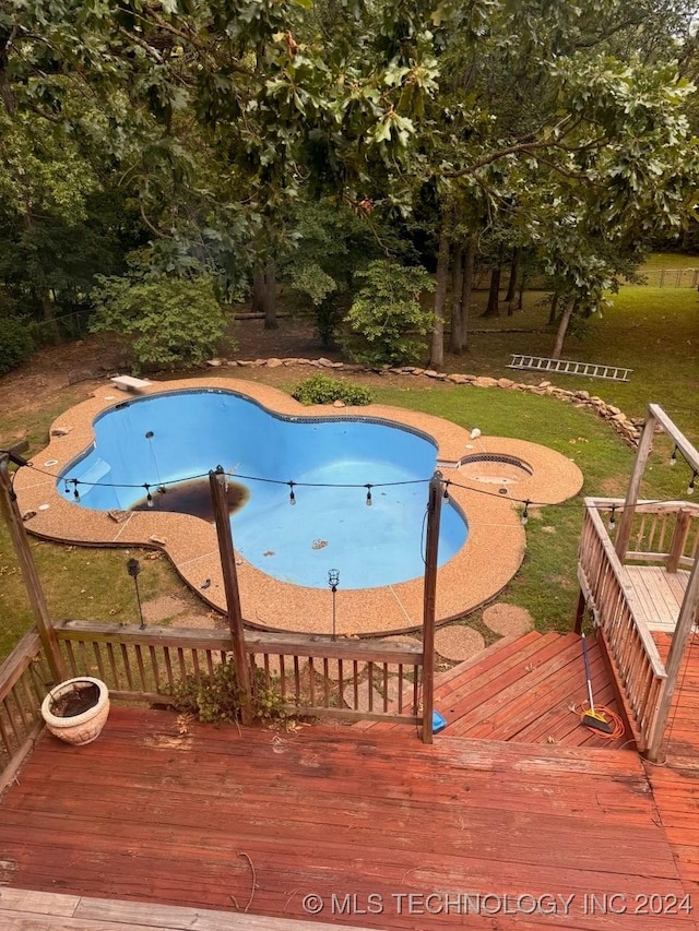 view of swimming pool featuring a diving board and a deck