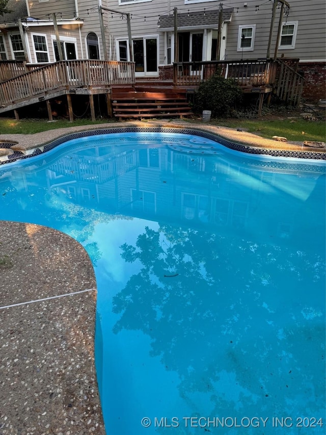 view of pool with a wooden deck