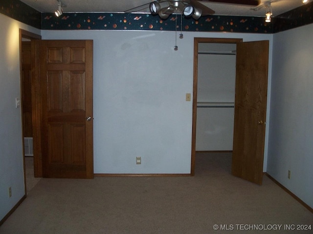 unfurnished bedroom with carpet and ceiling fan