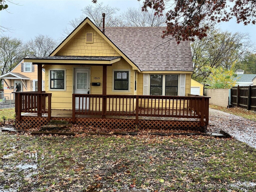 1915 S Dewey Ave, Bartlesville, OK 74003 - rear view of house with roof with shingles and covered porch