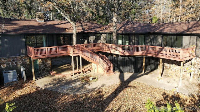 rear view of property featuring a deck