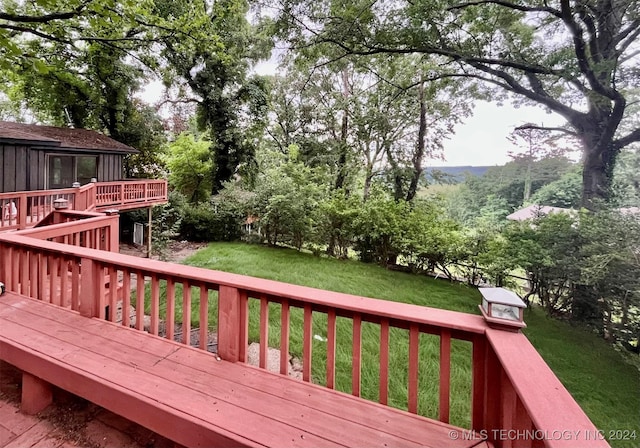 wooden deck with a lawn