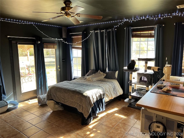 10722 E First St, Claremore, OK 74019 - bedroom with tile patterned floors, multiple windows, and ceiling fan