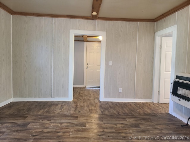 unfurnished room with beamed ceiling, dark hardwood / wood-style floors, and heating unit