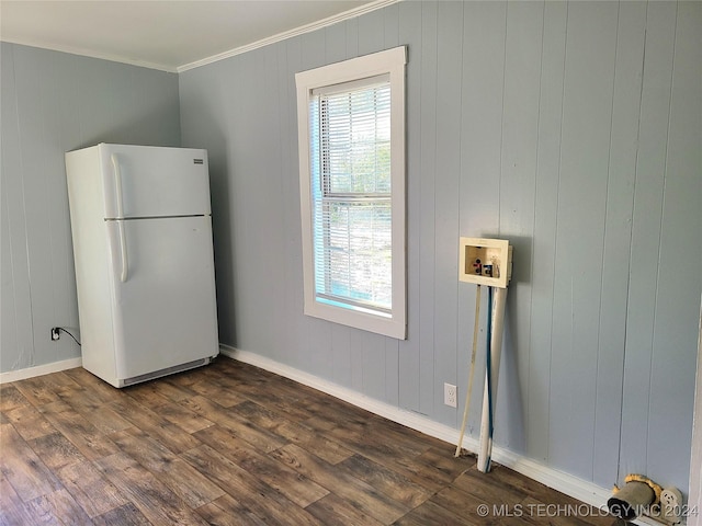 interior space with hookup for a washing machine, crown molding, wooden walls, and dark hardwood / wood-style floors