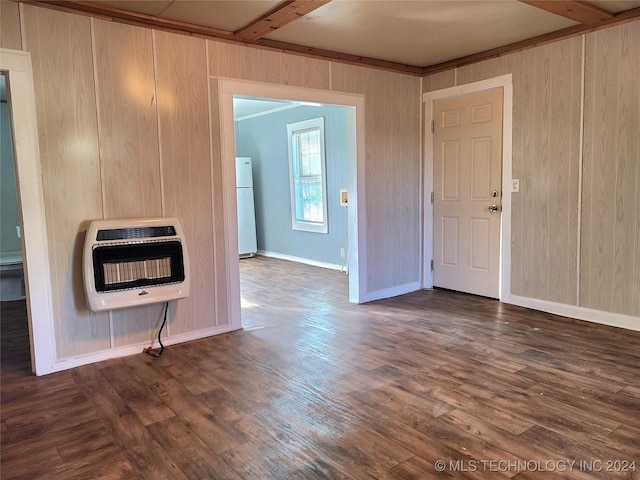 interior space featuring beamed ceiling, dark hardwood / wood-style flooring, heating unit, and wood walls