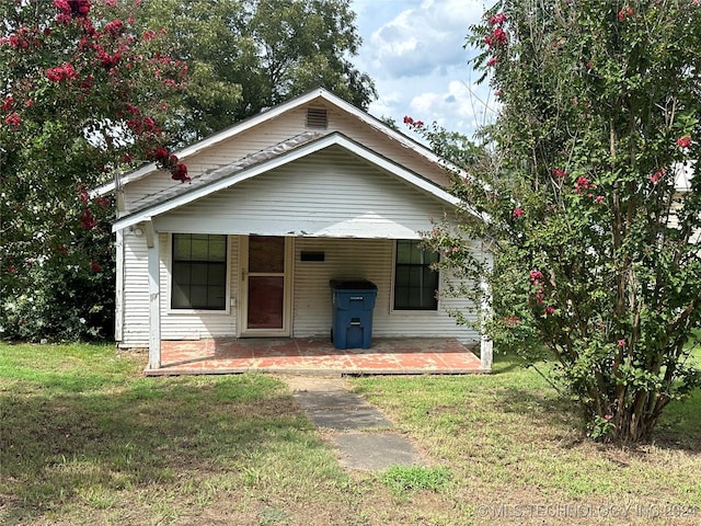 bungalow with a patio and a front yard