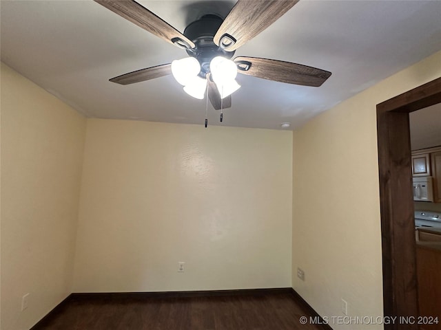 unfurnished room with ceiling fan and dark hardwood / wood-style flooring