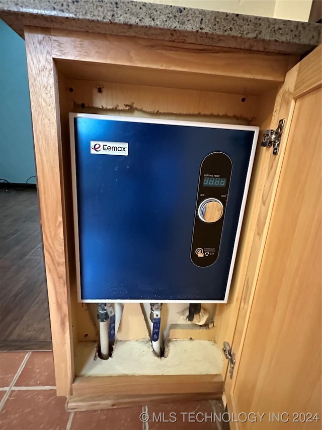 utility room featuring water heater