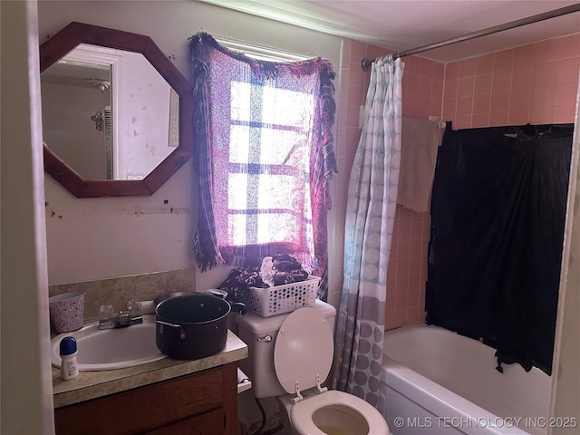 bathroom with shower / tub combo, vanity, and toilet