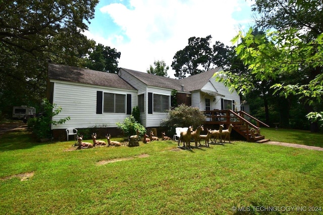 rear view of house with a yard